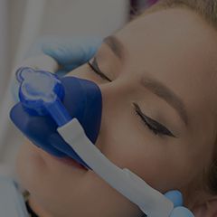 Woman with nitrous oxide nose mask